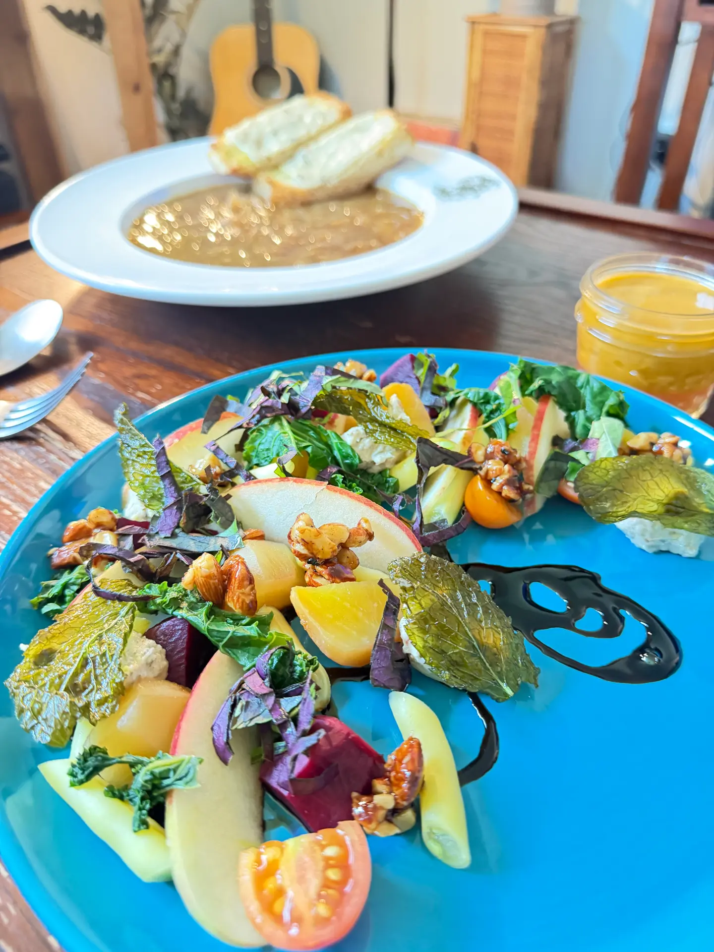 Beet and apple salad with walnuts on a blue plate
